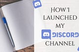 A blank notepad sits on a wood desk with a title of How I launched my discord channel