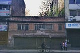 In Putalisadak, Kathmandu, Nepal, there is an old building where trees have grown in its roof.