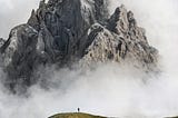 A hiker ready for a treacherous hike through a cloudy mountain, which represents the journey through their own mind.