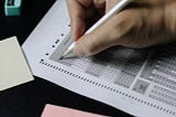 A person bubbles in answers on a standardized test.