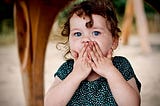 Toddler blowing a big kiss.