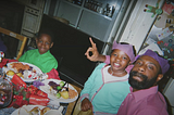 A black family enjoying Christmas dinner together.