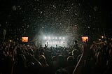 The crowd at night at a music festival