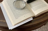 My photo of a book with a magnifying glass and red pen