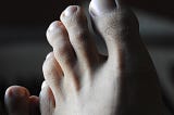 A close-up of a man’s toes.