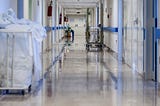 Photograph of a hospital hallway corridor.