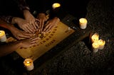 Hands on a Ouija Board, prognosticator of teenaged romances.