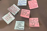 Post-it notes stuck to a table, displaying participants’ thoughts about a community gardening workshop at a project launch event