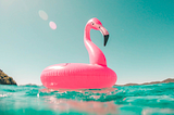 Pink inflatable flamingo floating on water