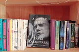 Photo of a bookshelf, with the cover of A Little Life facing forward.