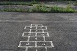 A hopscotch with the word ‘start’ and then numbers to 10 drawn in chalk on the pavement.