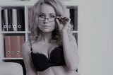 Sexy woman in bra and wearing glasses