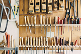 Photo of a wall of a workshop with handheld tools.