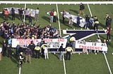 Over 200 Students Disrupt the Harvard-Yale Game to Demand Climate Justice