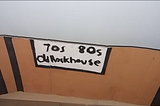 Handmade painted font inside a brown background with black straight lines in the corners