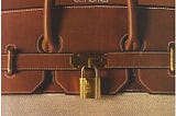 Birkin Ad featuring brown and beige bag