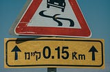 A road sign indicating rough roads and risky conditions ahead