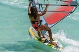 woman windsurfing in ocean — capable and strong