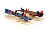 Two ship models with shield and damage pips slotted into them in different configurations.