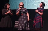 Karen Kilgariff, Olivia Standbridge and Georgia Hardstark on stage at the Hammersmith Apollo laughing.