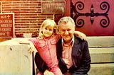 Photo of me and my dad. I’m around 8 or 9 years old. We’re sitting on church steps.