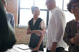 A girl shaking hands to signify collaboration for the blog Top six tools for effective DevOps collaboration