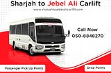 A white bus with black lettering and a red and white stripe running along the side. The bus has the text “Sans Transport” written in both Arabic and English on the side. There is also text that says “Sharjah to Jebel Ali Carlift” and “Coaster” The text includes phone numbers and a website. The background is white.
