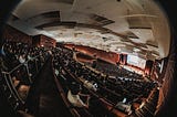 A fisheye perspective of the big auditorium — Hall 1 of the convention center in Hamburg — during the opening ceremony at CHI23.