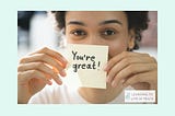 Decorative image of a woman holding a post it that says “You’re great!”.