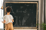 Unrecognizable girl solving mathematical problems near chalkboard · Free Stock Photo