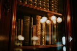 A bookshelf with hardbound books.