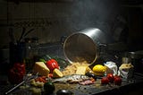 Google generated decorative image based on the phrase ‘recipe for disaster’, showing an overturned pot and food all over the counter.