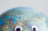 photo of a globe with googly eyes
