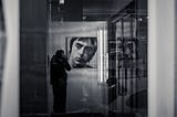 Man taking a photo of Paul Weller in the reflection