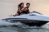 A happy couple on their zippy Narke Electrojet GT95 personal watercraft.