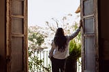 A thoughtful midlife woman walking alone outdoors, appearing calm, self-assured, and comfortable in her own company.