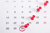 Calendar with four dates pinned and one circled