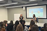 Image of author with interviewer at a fireside chat at Google SF with a sea of women watching