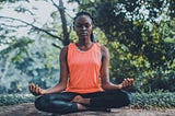 Young woman meditating outside