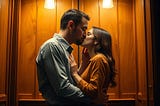 Image shows a man and woman kissing in an old-fashioned, wood-panelled lift.