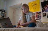 Teenager Browsing on Her Laptop