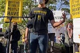 Image: Young activist stands and speaks in front of crowd