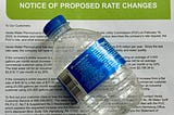 A empty water bottle and a water service rate change letter