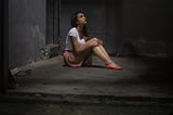 young-girl-in-white-shirt-in-concrete-room