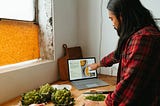 Micronutrients RDI and food — Man cooking and pointing at a laptop