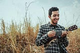 A guy singing happily in the wild.