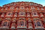 An intricate carvings of windows are seen in red stone of the iconic Hawa Mahal