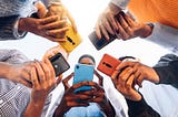 Five people using phones — group standing in circle