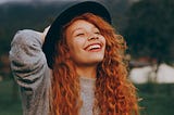 A red haired woman smiling