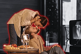 A couple having a connecting moment over some wine and food.